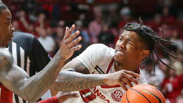Razorback guard Khalif Battle getting knocked out of bounds against Alabama